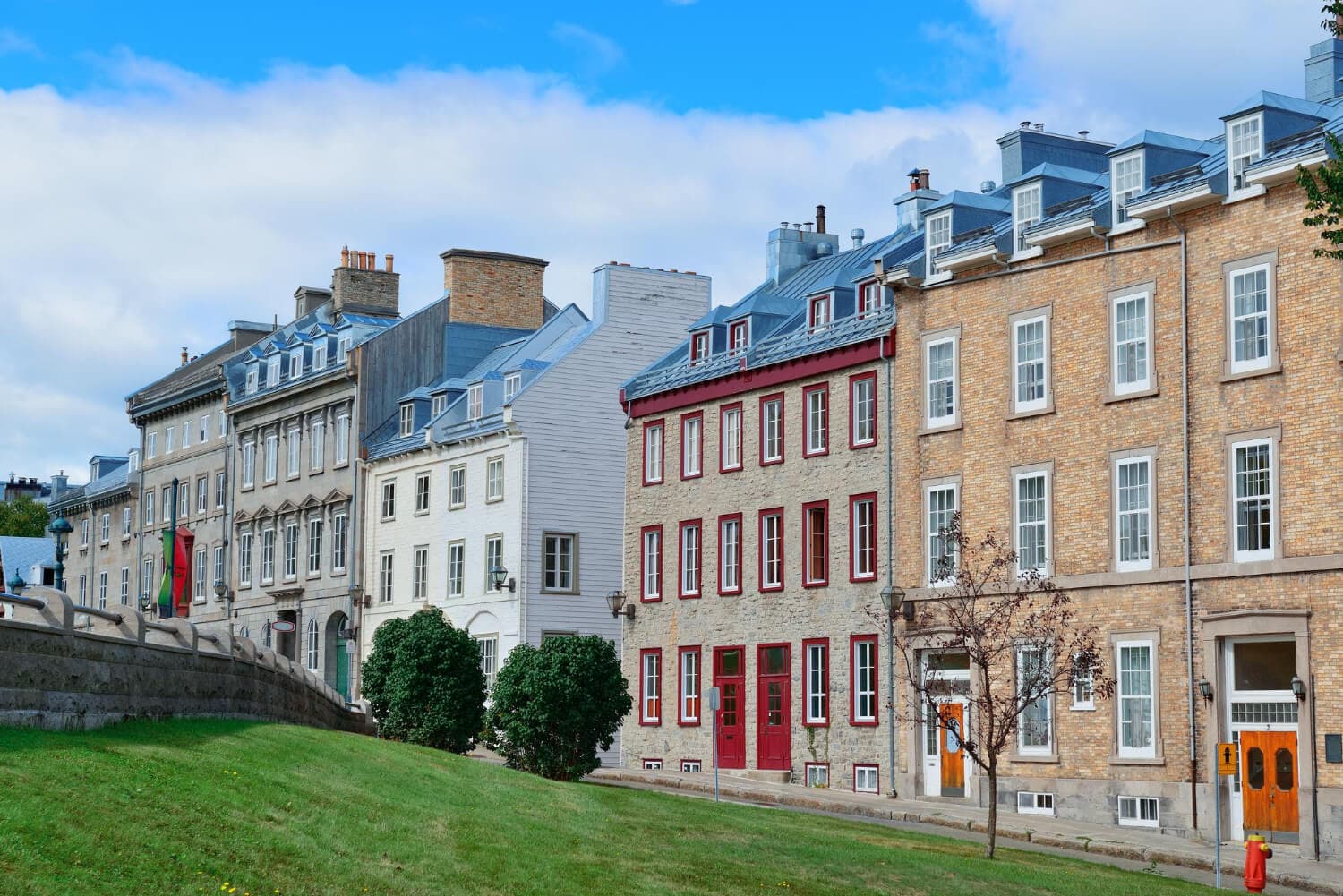 A row of historic homes beneath a blue sky