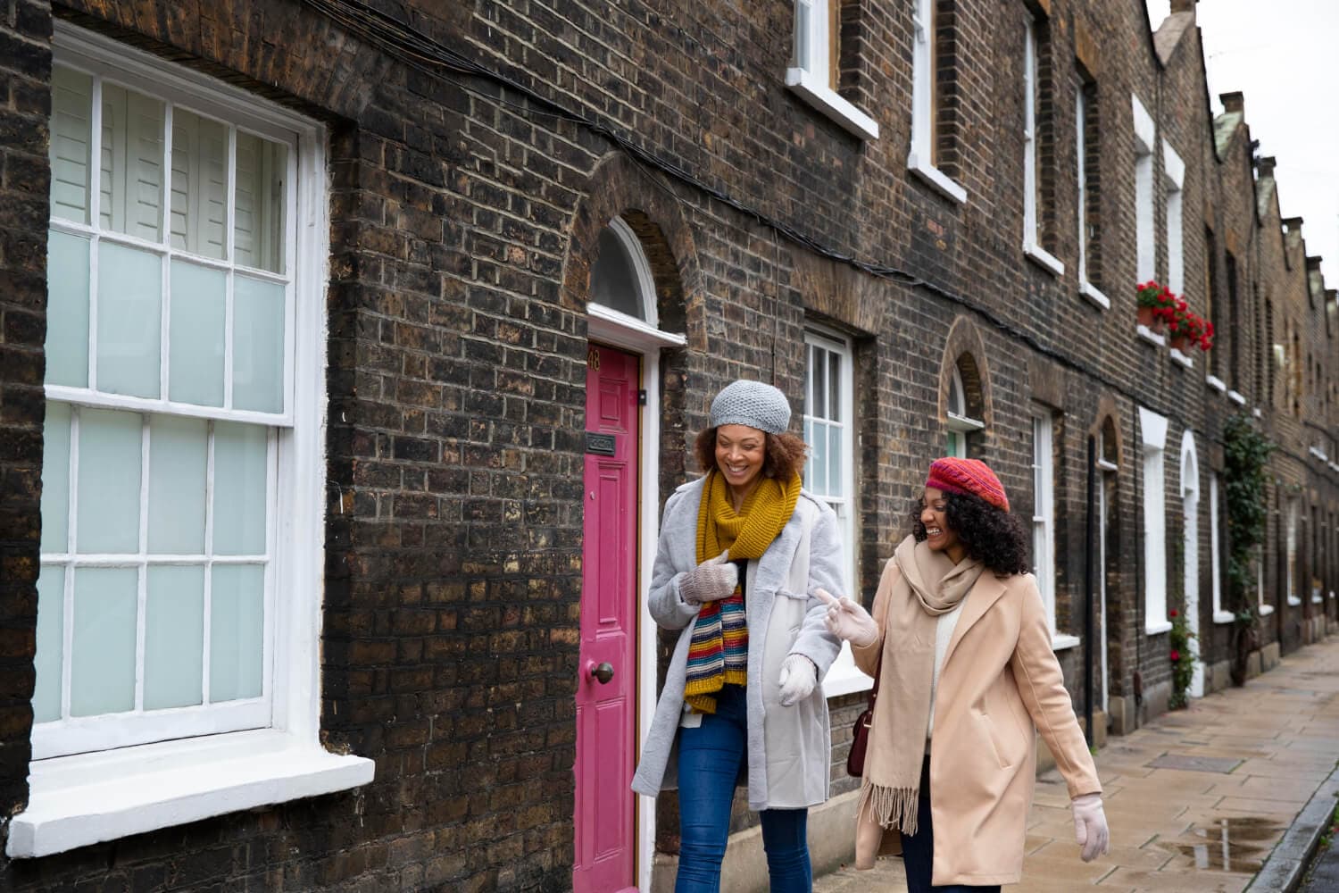 People walking along a row of London townhouses